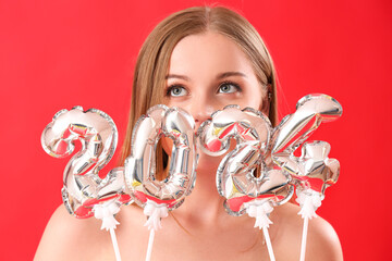 Canvas Print - Young woman with figure 2024 on red background, closeup