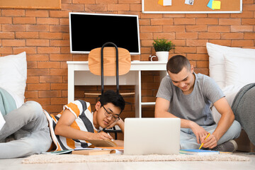 Wall Mural - Male students doing homework in dorm room