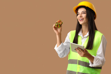 Wall Mural - Female worker with tablet computer and tasty sandwich on color background