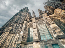 Partial View Looking Up At The Majestic Cologne Cathedral In Cologne, Germany. It Is The World’s Third Largest Gothic-style Cathedral, Germany's Most Popular Landmark And A UNESCO World Heritage Site.