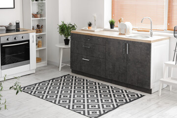 Poster - Interior of light kitchen with counters and carpet