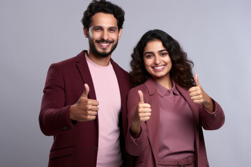 Canvas Print - Picture of man and woman showing their approval by giving thumbs up. Suitable for illustrating positive feedback and agreement in various contexts.