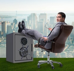 Wall Mural - Businessman resting putting leg on safe