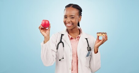 Sticker - Face, doctor and black woman with an apple, donut and healthcare on a blue studio background. Portrait, African person and medical professional with fruit, nutrition and decision with sweet treats