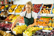 © JackF - Young salesgirl at her first job, selling green grape and other fruits in vegetable shop