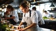 © Banana Images - A group of chef in uniform preparing delicious food for her cooking venture. Good job enviroment