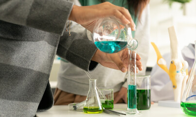 Children scientist doing science experiment test with chemistry in a laboratory. STEM - education and innovation professional concept.