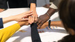 © KOTL - Business people putting hands together. Group of diversity team members expressing a cooperation teamwork moment.