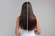 © New Africa - Photo of woman divided into halves before and after hair treatment on grey background, back view