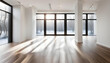 © anmitsu - A large, empty room with a wooden floor, white walls, and large windows that let in bright natural light.
