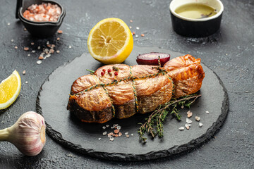 Wall Mural - Cooked salmon steak with herbs, lemon, olive oil, Grilled fresh fish for healthy dinner, Restaurant menu, dieting, cookbook recipe top view