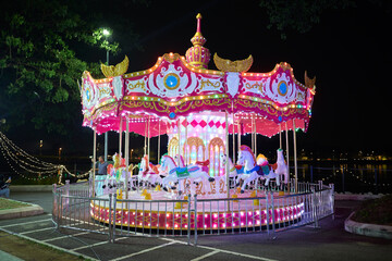 Illuminated classical carousel at night in Ipoh city