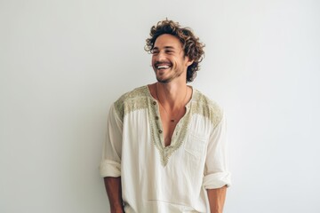 Wall Mural - Portrait of a handsome young man smiling while standing against white background