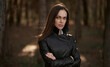 © spaxiax - woman is wearing black leather jacket in the autumn park