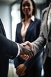 closeup shot of a group of businesspeople shaking hands while standing together in an office
