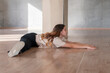 young girl doing leg-split stretching in the studio, dancer doing practice