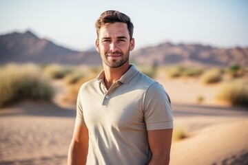 Wall Mural - Portrait of handsome man standing in the desert on a sunny day