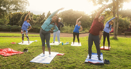 Canvas Print - Multiracial senior people doing stretching workout exercises outdoor with city park in background - Healthy lifestyle and joyful elderly lifestyle concept - Soft focus on right man face