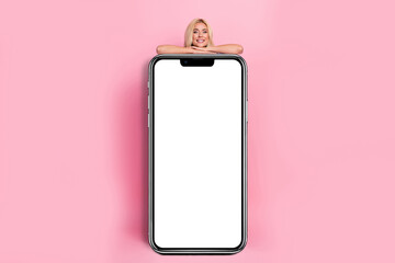 Sticker - Full size portrait of cheerful nice girl behind big empty space telephone display isolated on pink color background