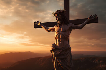 Jesus Christ crucified on the cross on hill with sunset sky in background.