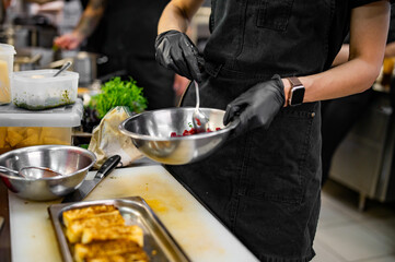 Wall Mural - professional chef's hands cooking Raw beef meat tartar in restaurant kitchen