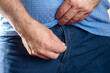 a man zips up his trousers