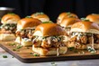 juicy bbq pork sliders with spicy aioli on a slate serving board