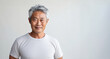 Portrait of a middle aged asian male model with grey hair isolated on white background. Wearing a blank white shirt. Handsome Elderly with white blank tshirt