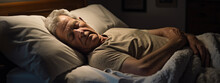 Senior man sleeps in a bed at home