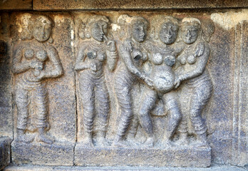 Bas relief of Pregnant Woman giving child birth with Labor Women's. Relief sculpture carved in stone wall at Airavatesvara Temple in Darasuram, Kumbakonam, Tamilnadu.