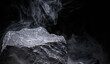 Mountain rock and floating smoke on a black background are for displaying product
