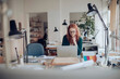 © Geber86 - Young female architect working on the laptop in a modern business office