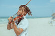 passionate man playing violin on the beach