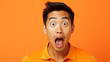 A asian man doing a shocked look on tan background