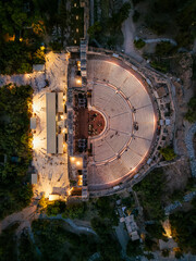 Wall Mural - Aerial top down view of the ancient Odeon of Herodes Atticus below the Acropolis of Athens, Greece, during dusk