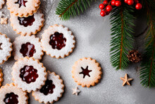 Linzer Cookies With Sweet Jam And Fir Tree Branches On Wooden Table. Top View