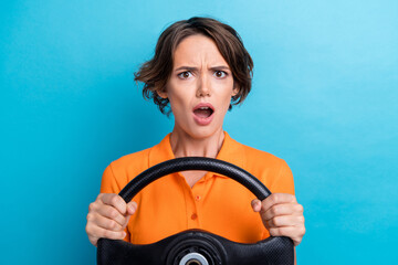 Sticker - Photo of scared shocked girl dressed orange polo riding auto stuck in traffic jam isolated blue color background