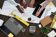 © pressmaster - Top view of hands of two young intercultural architects discussing new sketch of building and pointing at blueprint at working meeting