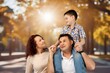© BillionPhotos.com - Happy young parents with children outdoor, AI generated image