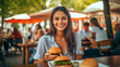 A happy girl eating a burger in an outdoor restaurant as a Breakfast meal craving deal.generative ai
