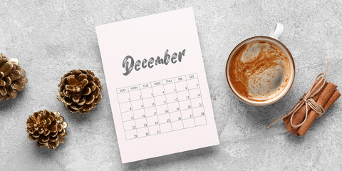 Wall Mural - Calendar for December with cup of coffee, fir cones and cinnamon on grunge background