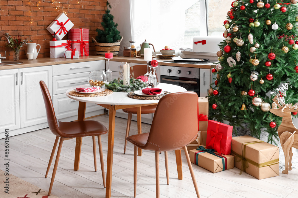 Kitchen interior with Christmas tree, new year decorations and served table