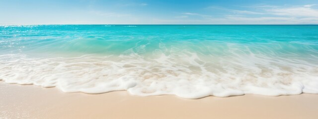 Wall Mural - Sun-kissed beach sand beneath turquoise waves background.