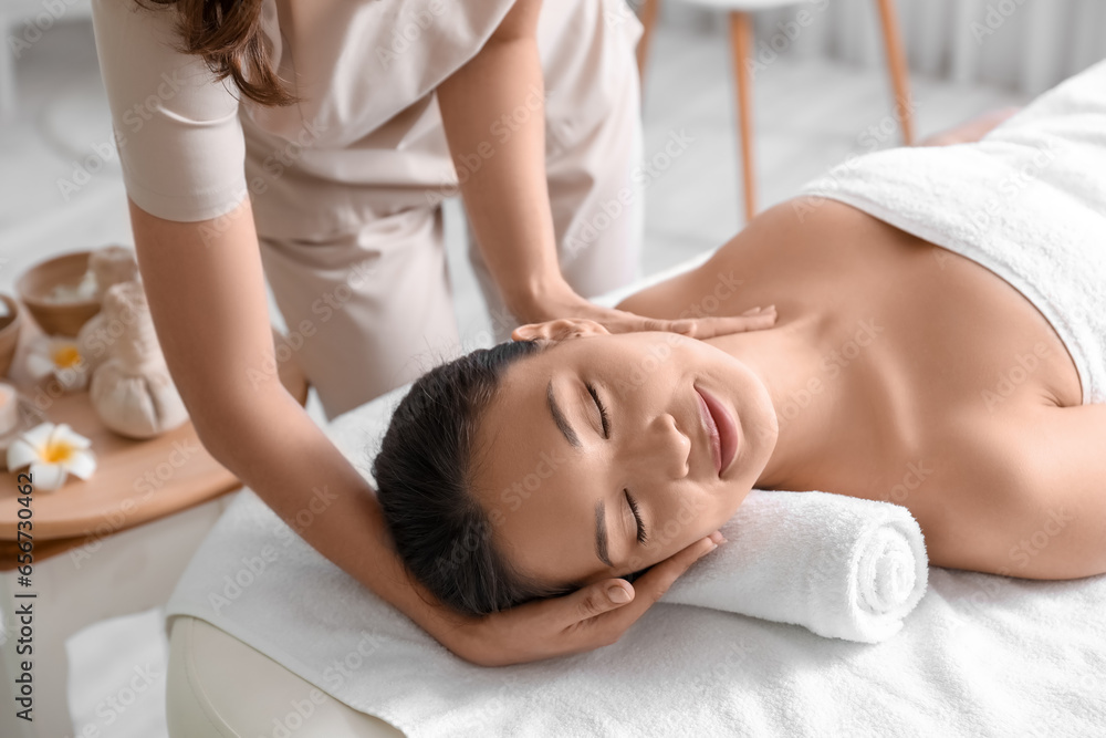 Young woman having massage in spa salon, closeup