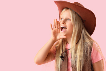 Wall Mural - Little cowgirl shouting on pink background, closeup