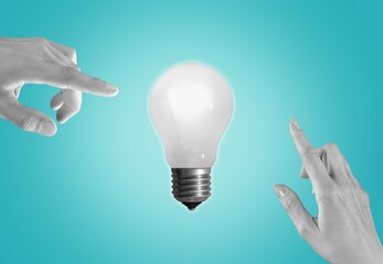Wall Mural - hand reaching to light bulb. energy concepts