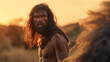Illuminated by a fiery sunset, a Neanderthal with a robust physique and a thoughtful expression appears deeply connected to the land, surrounded by tall grasses and rolling hills.
