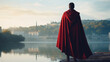 Standing on the banks of the Tiber River, a legionnaire gazes out into the horizon, his red cape fluttering in the wind, creating a striking contrast against the calm waters.