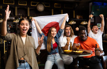 Emotional Young Female Fan Watching Football Match In Sports Bar, Gesturing Emotionally, Happy With Victory Of Favorite Japanese Team