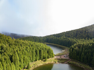 Wall Mural - Aerial view of Lake of Empadadas (Lagoa das Empadadas) surrounded by trees on a cloudy day. Sete Cidades Sao Miguel island in the Azores